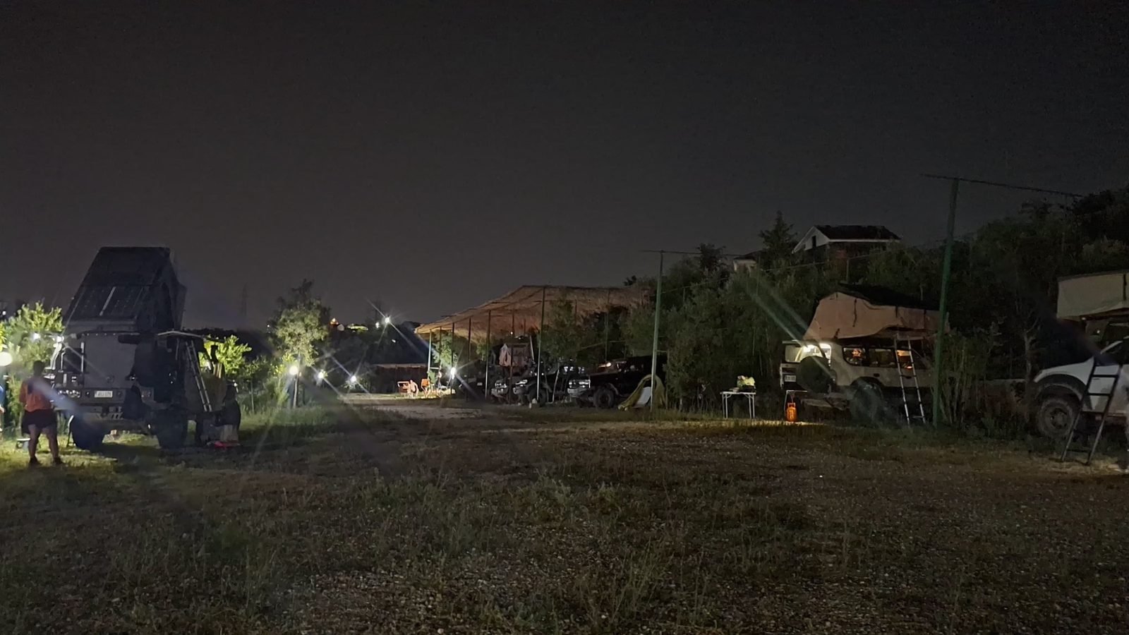 Overland trucks with rooftop tents at the camp at night